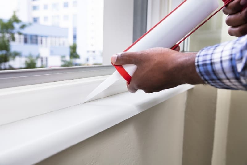 Person Hand Applying Silicone Sealant With Silicone Gun