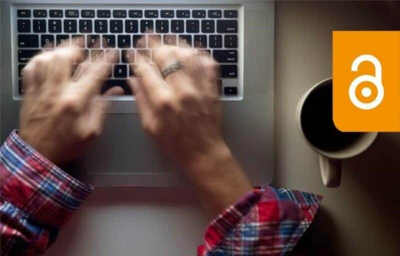 Hands of a person typing on a laptop keyboard