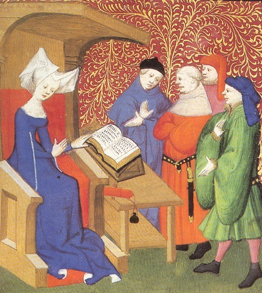 Christine de Pizan lecturing to a group of men. She is seated in a chair or cathedra.