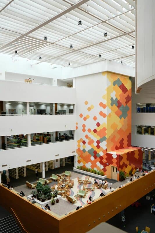 Picture of Macau University's library. The modern open space interior is flooded with daylight.