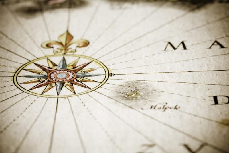 Drawing of a compass on an antique map