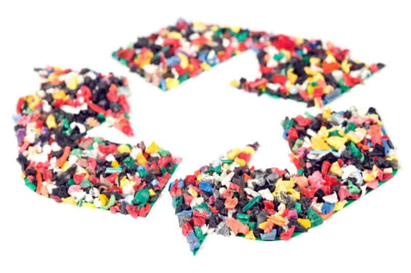 Recycling symbol made up of numerous tiny plastic pieces